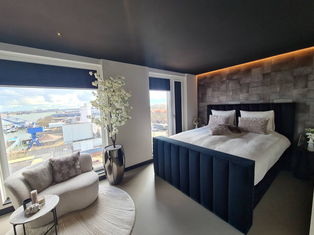 Slaapkamer met donker spanplafond en sfeerverlichting